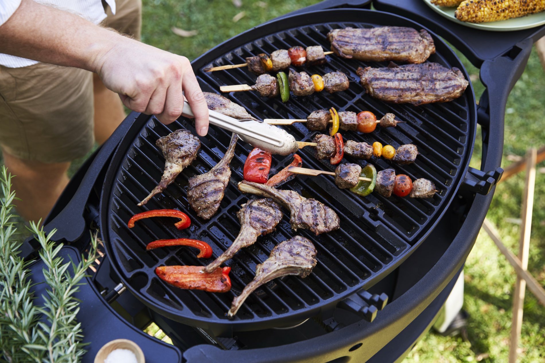 Lamb cutlets and skewers cooking on a barbecue grill
